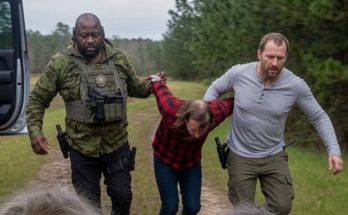 armed men escorting captive