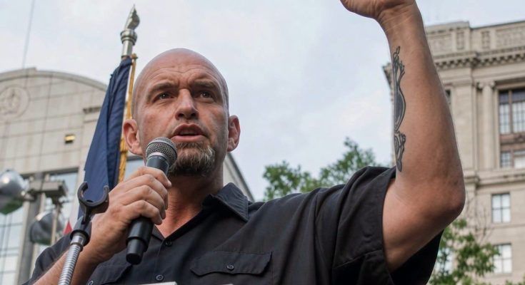 man speaking at rally