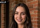 smiling woman brick wall
